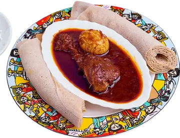 Doro Wot with an egg in a red sauce, served with injera.