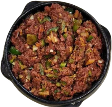 Dulet topped with chopped greens in a black dish.