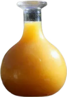 Golden tej in a narrow-necked glass carafe.