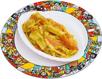 Tikil Gomen: yellow cabbage and carrots beside injera.