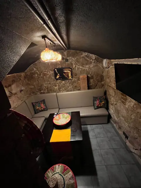 The private room, with a corner sofa and a low table under a woven lamp.
